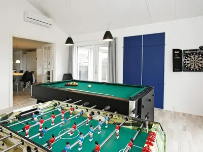 a room with a pool table with toy people on it at Luxury Spa Retreat by Sea in Vrist
