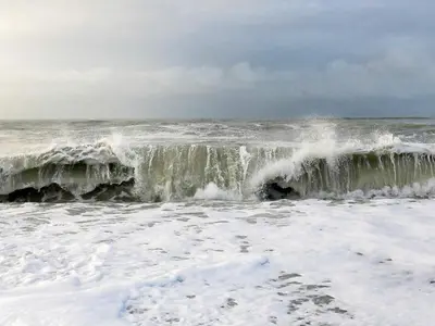 a large wave in the ocean on a cloudy day at Luxury Spa Retreat by Sea in Vrist