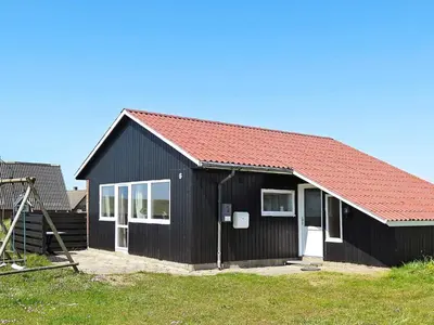 a black house with a red roof at Seaside Retreat with Sauna - By Traum Ferienwohnungen in Vrist