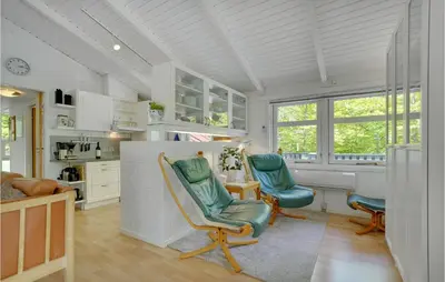 a kitchen with two chairs and a desk in a room at Holiday Home Saltum Doggerbanke in Saltum