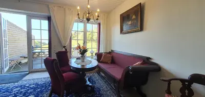 a living room with a couch and a table at Næsbydale Badehotel in Ranum