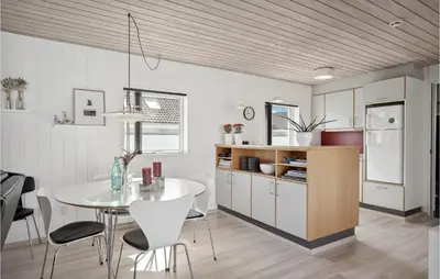 a kitchen and dining room with a table and chairs at Two-Bedroom Holiday Home In Pandrup in Pandrup
