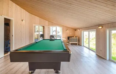 a pool table in a room with wooden walls at Four-Bedroom Holiday Home In Thisted in Thisted