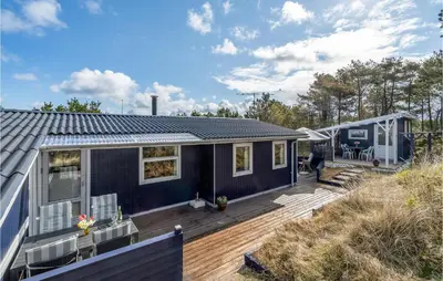 a blue tiny house on a wooden deck at Two-Bedroom Holiday Home In Thisted in Thisted