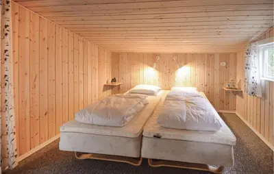 a bedroom with two beds in a wooden room at Two-Bedroom Holiday Home In Thisted in Thisted
