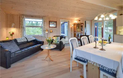 a living room with a couch and a table at Two-Bedroom Holiday Home In Thisted in Thisted