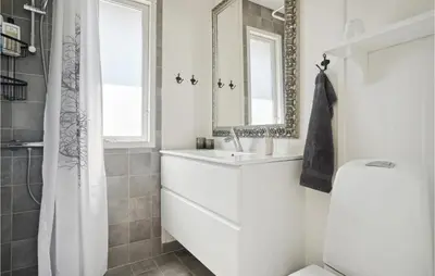 a white bathroom with a sink and a mirror at Three-Bedroom Holiday Home In Thisted in Nørre Vorupør
