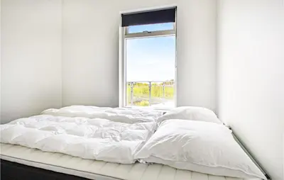 a white bed in a room with a window at Three-Bedroom Holiday Home In Spottrup in Spottrup