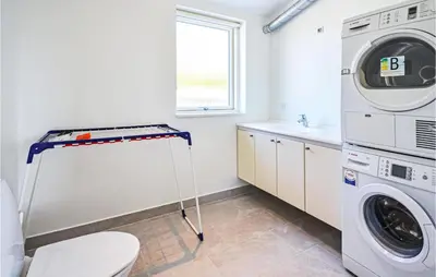 a laundry room with a washer and dryer at Three-Bedroom Holiday Home In Spottrup in Spottrup