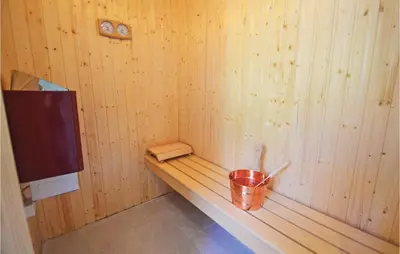 a small wooden room with a bucket and a tv at Three-Bedroom Holiday Home In Spottrup in Spottrup