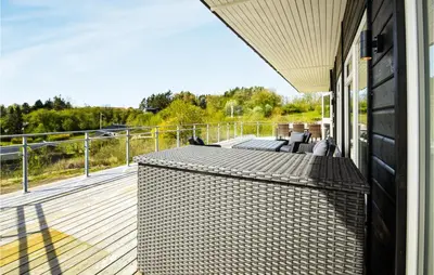 a balcony of a house with a wooden deck at Three-Bedroom Holiday Home In Spottrup in Spottrup