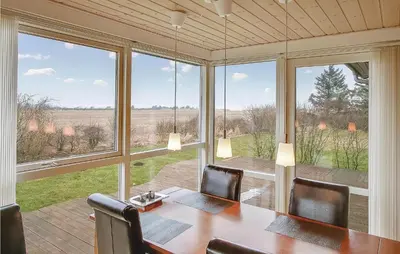 a dining room with a table and a large window at Awesome Home In Vinderup With Wifi in Vinderup