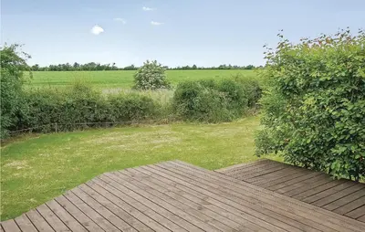 a wooden deck with a view of a field at Awesome Home In Vinderup With Wifi in Vinderup