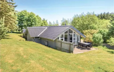 a house with a solar roof on top of a field at Four-Bedroom Holiday Home In Spottrup in Spottrup