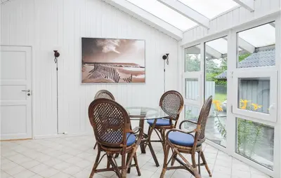 a dining room with a glass table and chairs at Four-Bedroom Holiday Home In Spottrup in Spottrup