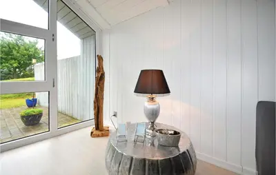 a room with a table with a lamp on it at Four-Bedroom Holiday Home In Spottrup in Spottrup