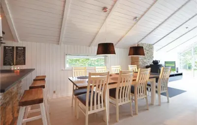 a dining room with a table and chairs at Four-Bedroom Holiday Home In Spottrup in Spottrup