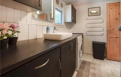 a kitchen with a sink and a counter top at Three-Bedroom Holiday Home In Spottrup in Spottrup