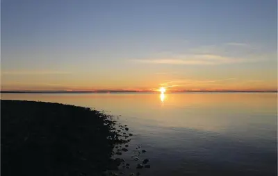 a sunset over a large body of water at Three-Bedroom Holiday Home In Spottrup in Spottrup