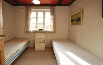 two beds in a room with a window at Three-Bedroom Holiday Home In Spottrup in Spottrup