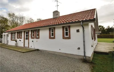 a small white building with a red roof at Three-Bedroom Holiday Home In Spottrup in Spottrup