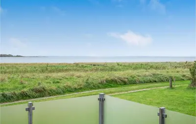 a view of the beach from the balcony of a house at Three-Bedroom Holiday Home In Skals in Skals