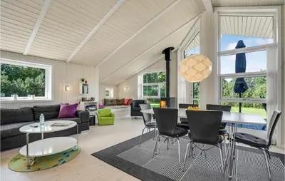 a living room with a table and chairs at Two-Bedroom Holiday Home In Logstor in Løgstør