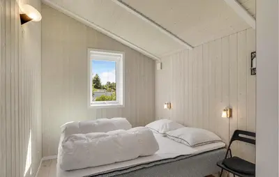 a white bed in a room with a window at Two-Bedroom Holiday Home In Logstor in Løgstør