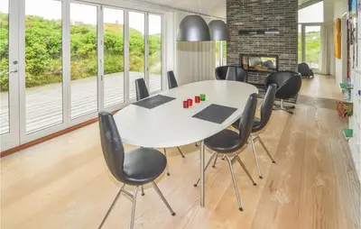 a meeting room with a white table and black chairs at Stunning Home In Løkken With Kitchen in Løkken