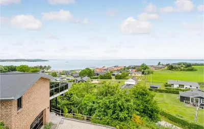an aerial view of a house with the ocean in the background at Three-Bedroom Holiday Home In Farso in Farsø