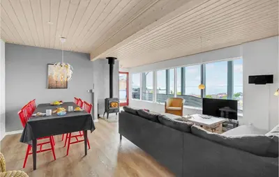 a living room with a couch and a table at Three-Bedroom Holiday Home In Farso in Farsø
