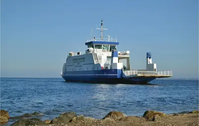 a large ferry boat sitting in the water at Three-Bedroom Holiday Home In Farso in Farsø