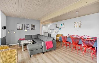 a living room with a couch and a table and chairs at Three-Bedroom Holiday Home In Farso in Farsø