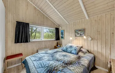 a bedroom with a bed and a window in it at Three-Bedroom Holiday Home In Hurup Thy in Sindrup
