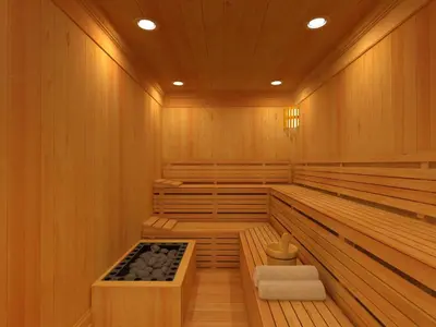 a sauna with wood paneling and a wooden floor at Strandhotellet in Blokhus