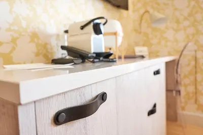 a kitchen counter with a appliance on top of it at Strandhotellet in Blokhus