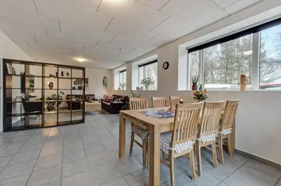 a living room with a wooden table and chairs at B & B Langagergaard in Thisted