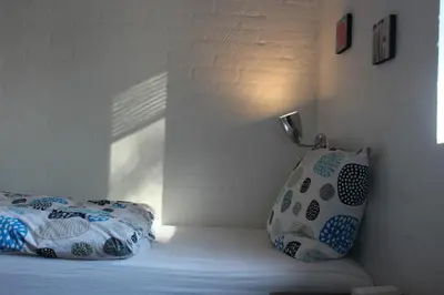 a bed with two pillows sitting next to a wall at B & B Langagergaard in Thisted