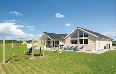 a house with a yard with a playground at Seven-Bedroom Holiday Home In Spottrup in Spottrup
