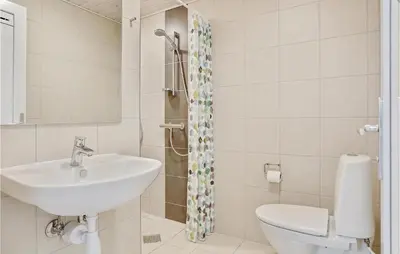 a bathroom with a sink and a toilet at Seven-Bedroom Holiday Home In Spottrup in Spottrup