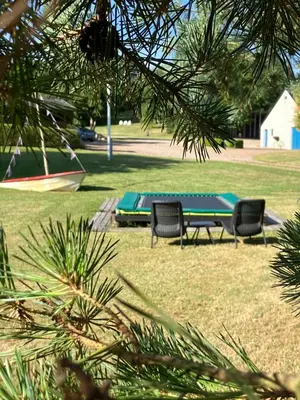 two chairs and a picnic table in a park at Porshus Ferielejlighed in Sundstrup
