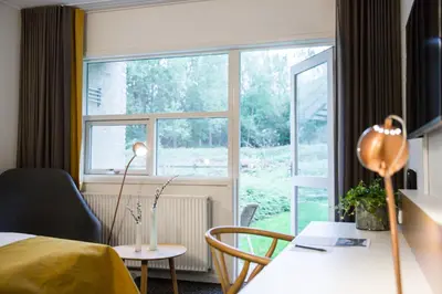 a hotel room with a bed and a window at Comwell Rebild Bakker in Skorping