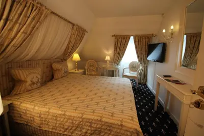 a bedroom with a bed and a television in it at Store Restrup Manor House in Store Restrup