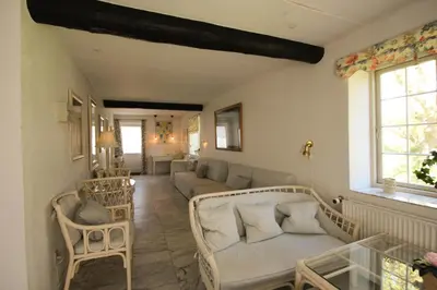a living room with a couch and chairs in it at Kokkedal Slotshotel in Brovst