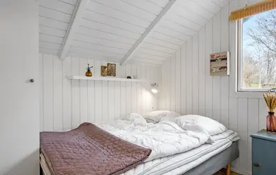 a white bed in a room with a window at Three-Bedroom Holiday Home In Thyholm in Thyholm
