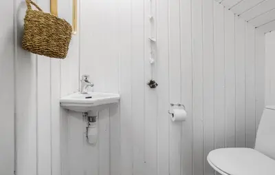 a white bathroom with a sink and a toilet at Three-Bedroom Holiday Home In Thyholm in Thyholm