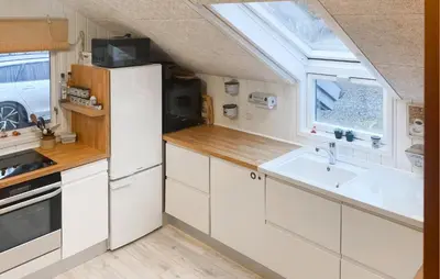 a kitchen with a white refrigerator and a sink at Three-Bedroom Holiday Home In Thyholm in Thyholm