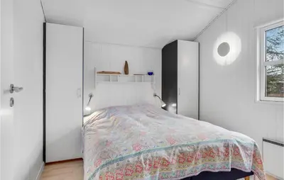 a bedroom with a bed and white walls and a window at Four-Bedroom Holiday Home In Fjerritslev in Fjerritslev