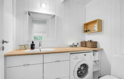 a white kitchen with a washing machine and a sink at Four-Bedroom Holiday Home In Fjerritslev in Fjerritslev