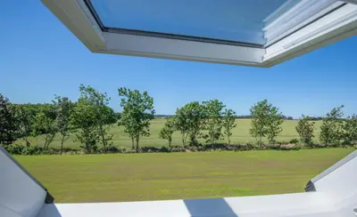 a view of a field from the window of a house at Kunstart20 in Saltum